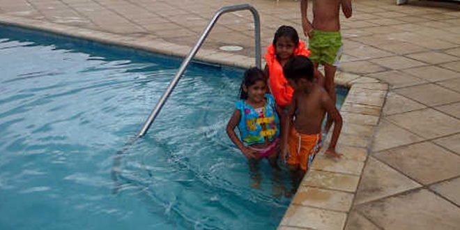 The Ali family in a pool at Crown Point, in sweet T&T for Sweet TnT Magazine, Culturama Publishing Company, for news in Trinidad, in Port of Spain, Trinidad and Tobago, with positive how to photography.