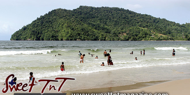Bathers at Maracas the popular beach, mountain, sand and sea, Caribbean sea, Sweet T&T, Sweet Trinidad and Tobago. Water supply in Trinidad.