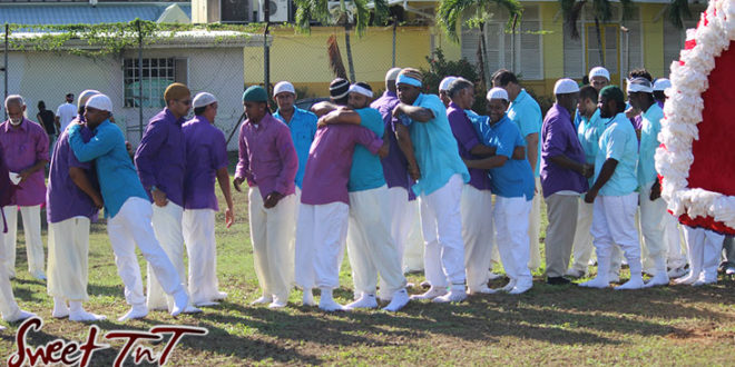 Hosay Muslim men hug, peace offering, brotherly love in Sweet T&T, Sweet TnT, Trinidad and Tobago, Trini, Travel, Vacation, Tourist, Hosay, Muslim, Parade, Tomb, Drummers, Funeral Procession, Woodbrook, St James, St Clair, Palm, Dancing the moon, Tadjahs, Moons, Tadjahs, mosques, Hussein, Hassan, tombs, tassa side, two moons, Husayn, Hassan