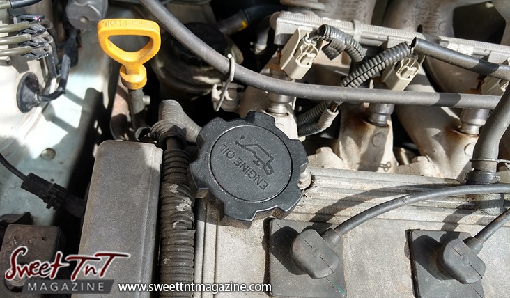 Engine of car, dip stick, oil cap, for car care tips article, in sweet T&T for Sweet TnT Magazine, Culturama Publishing Company, for news in Trinidad, in Port of Spain, Trinidad and Tobago, with positive how to photography.