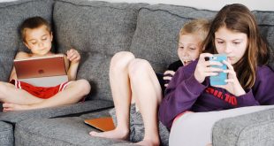 New normal: Children lying on sofa and using gadgets.