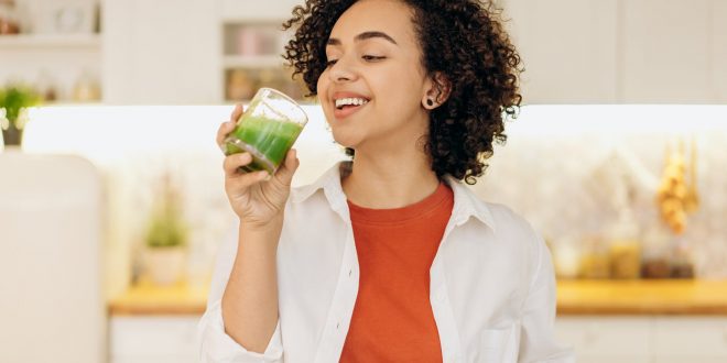 Top 10 Vitamins for Beauty, woman in white blazer drinking a fresh smoothie