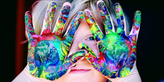 Occupy children. A kid with multicolored hand paint