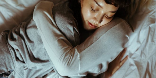 women hugging in bed