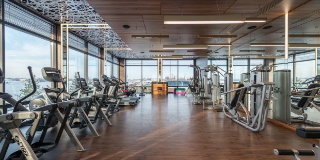 Health and Fitness. Various fitness machines in modern spacious gym