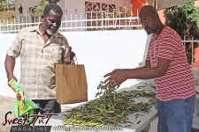 A satisfied customer purchases fresh Pigeon Peas. Pigeon Peas Festival